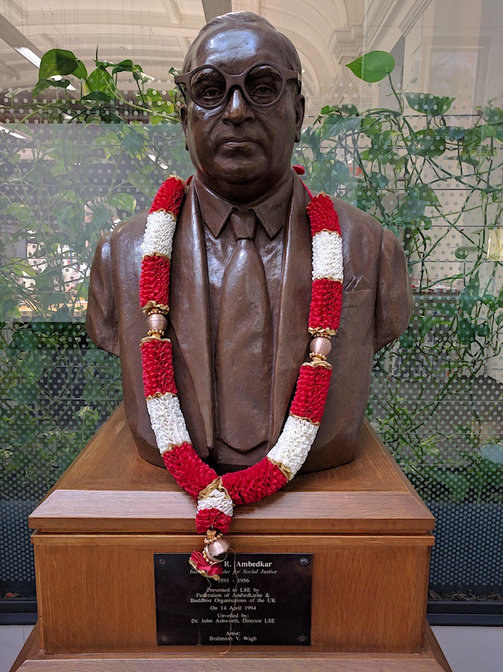 A bust of Ambedkar wearing glasses.