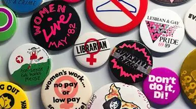 An assortment of colourful pin badges on a table