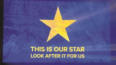 A gold stat on a blue background with "This is our star, look after it for us" written on it.