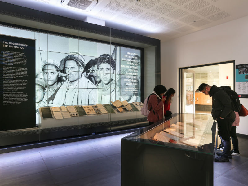 People looking at the exhibition material