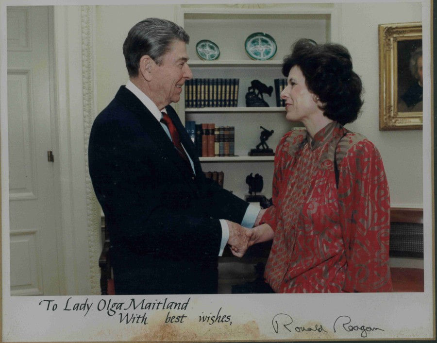 US President Ronald Reagan in the Oval Office shaking hands with Lady Olga Maitland.