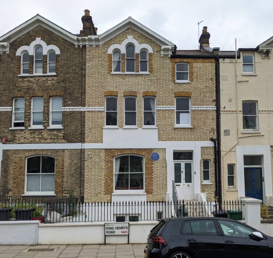 A photograph of the front of the house that Ambedkar lived in in London. There is a blue plaque of commemoration on the wall