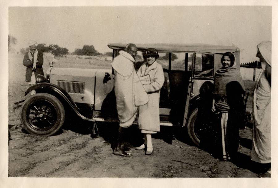 A photograph of Mahatma Gandhi, Agnes Maude Royden, Aruna Asaf Ali, Mirabhn, c.1934. Standing in front of a car