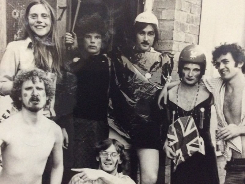 A black and white photo of a group of men in fancy dress outfits