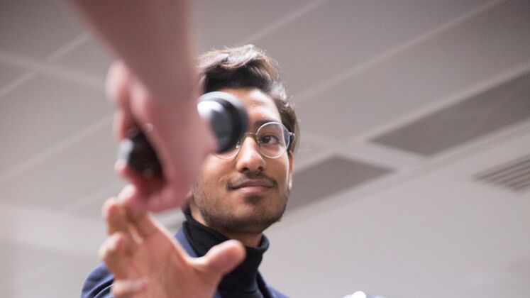 A man receives a microphone from a steward at an LSE event