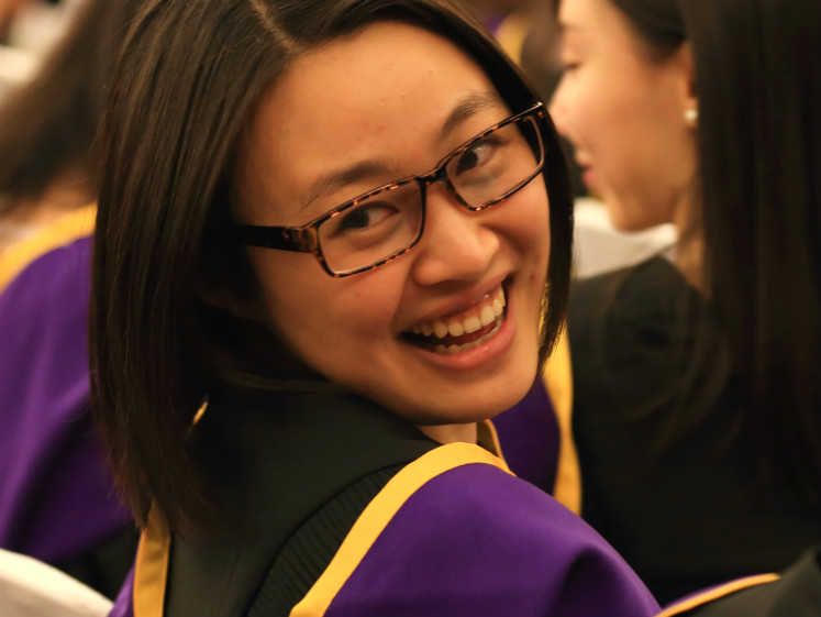 Graduate smiles over her shoulder