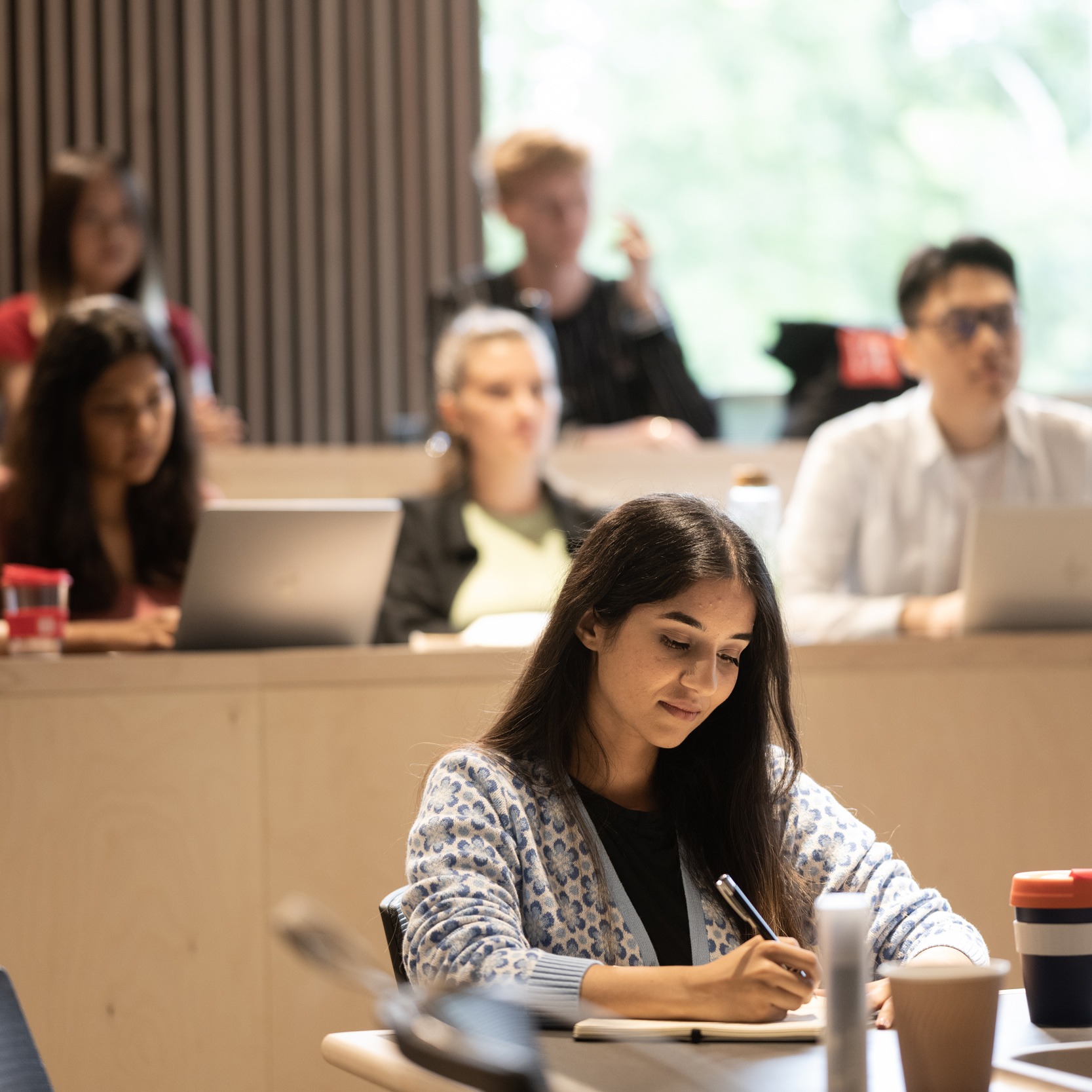 six department of management students learning in classroom in marshall building