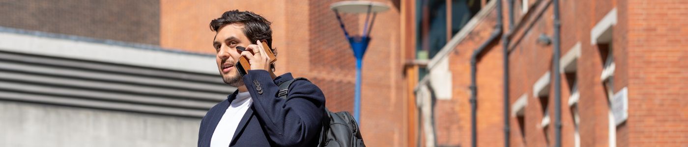 Man on the phone in front of the SU at LSE