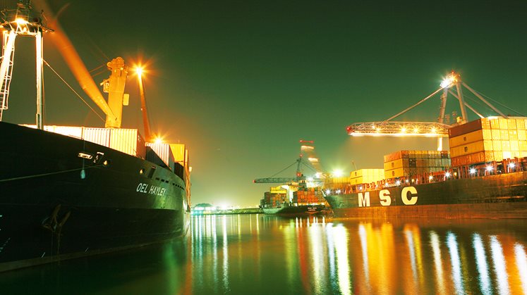 A night time shot of ships carrying cargo in Shuwaikh Port, Kuwait. 