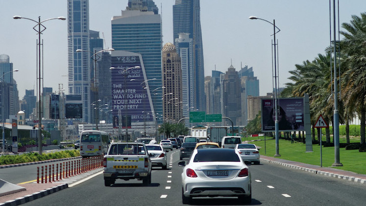 Cars on a highway driving into Dubai.