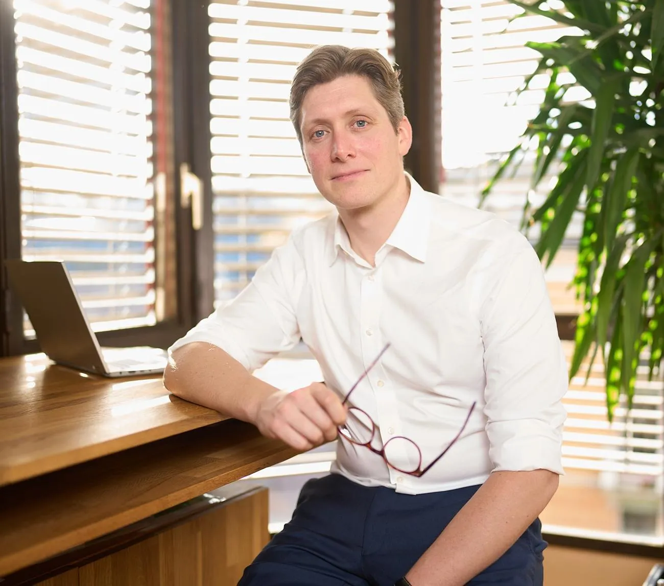 Dr Alex Carter sitting at a desk 