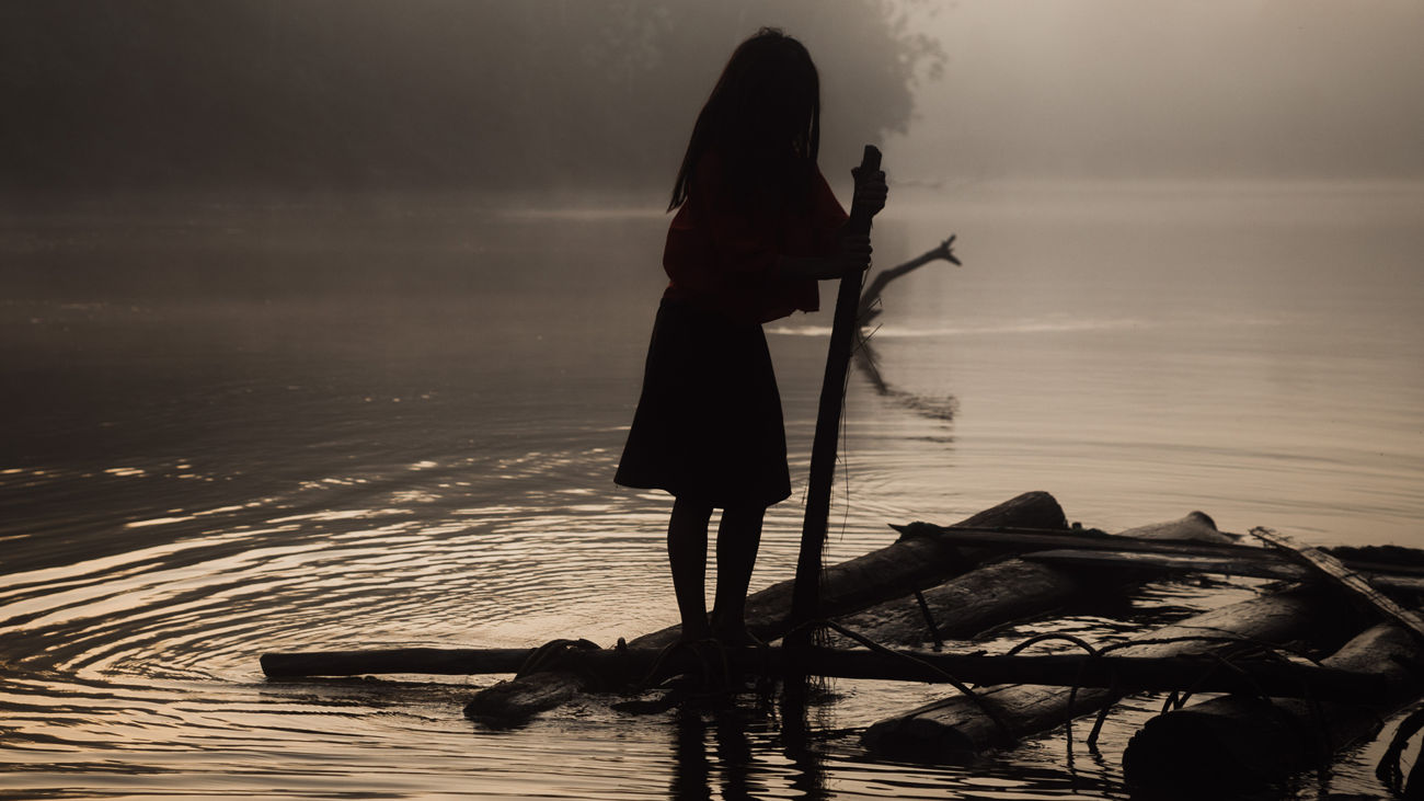 Urarina girl on a raft in Amazon