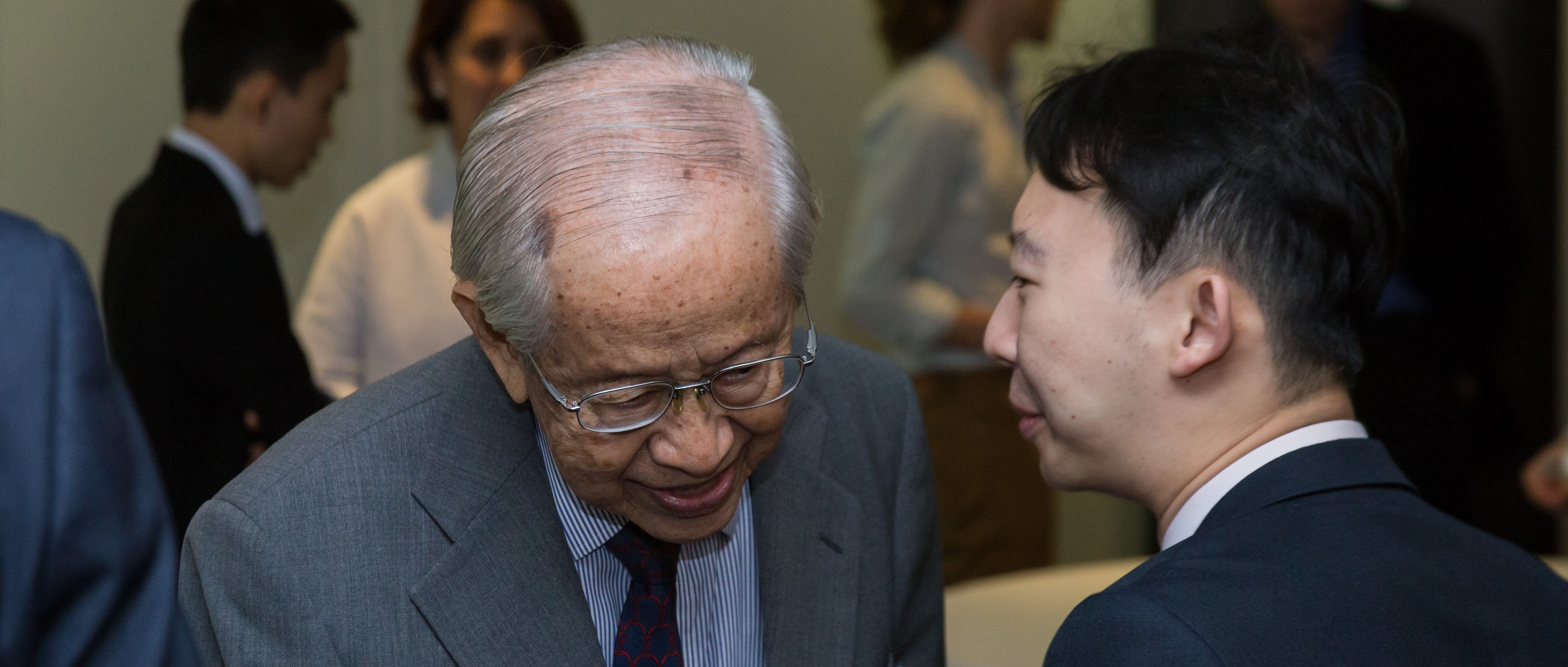 Professor Saw Swee Hock talking to a student