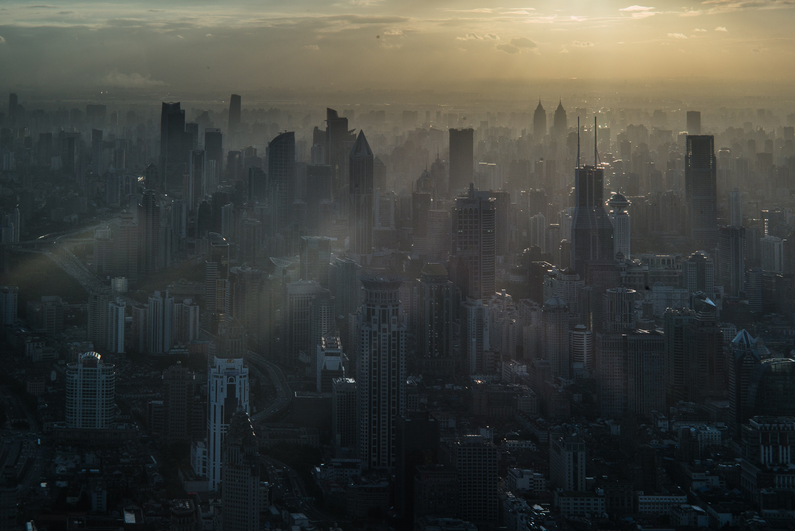 Sunshine breaking through smoggy skyscrapers in Shanghai