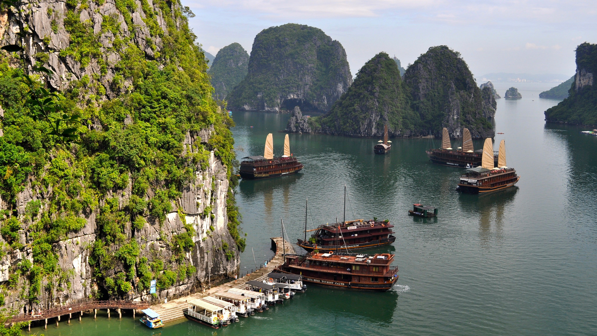 Vietnamese junk ships in a bay with mountains