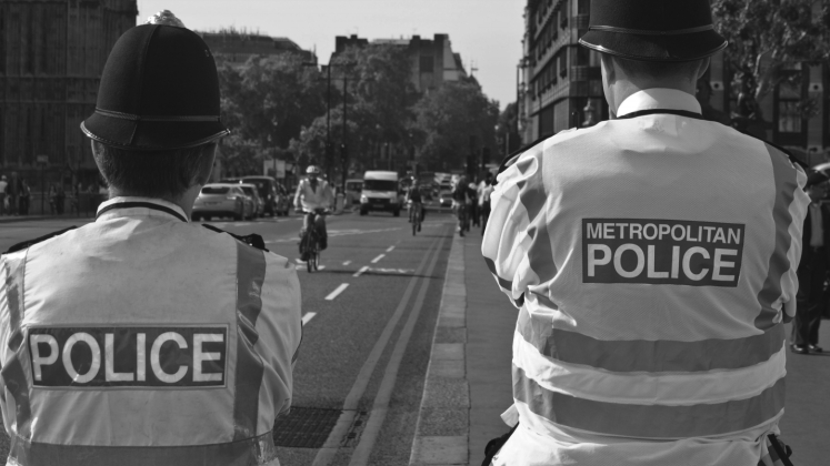 Close up of two police jackets saying police