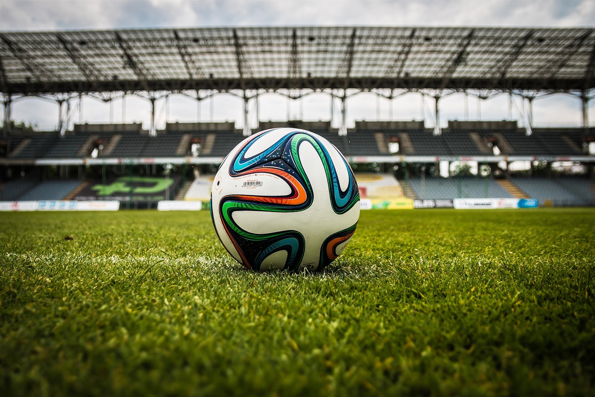 A close up of a football on a pitch.