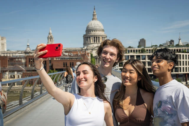 Four Summer School students taking a selfie on Millennium Bridge