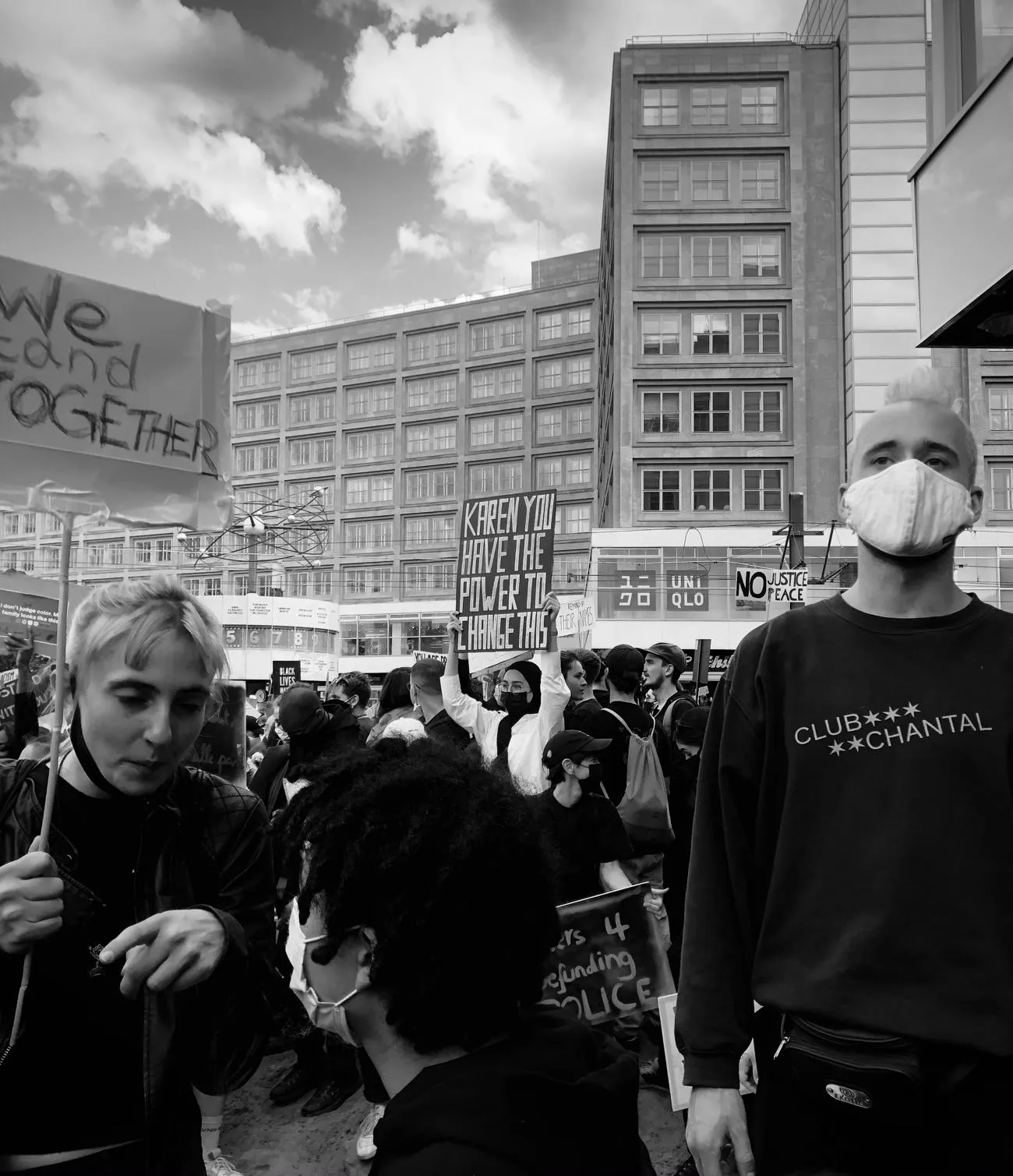Crowds at protest holding 'we stand together' sign
