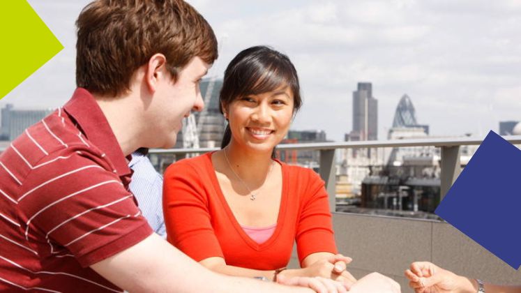 Two students talk on the roof of the New Academic Building