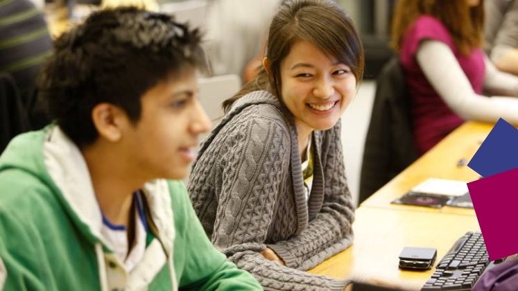 Two students talking in the LSE Library