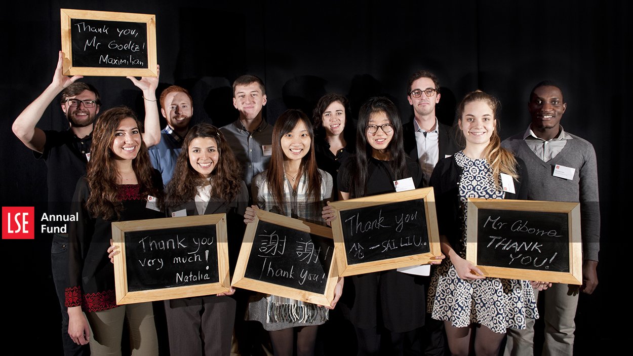 LSE scholarship recipients holding signs saying 'thank you'